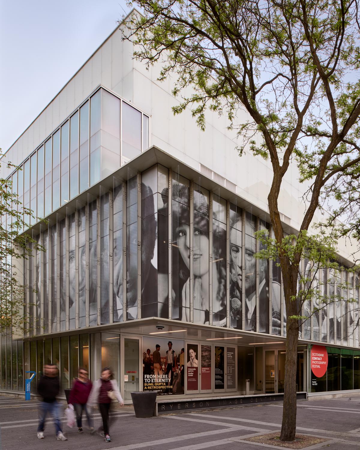 Corner of the gallery building featuring second floor window facade portraits of Canadians