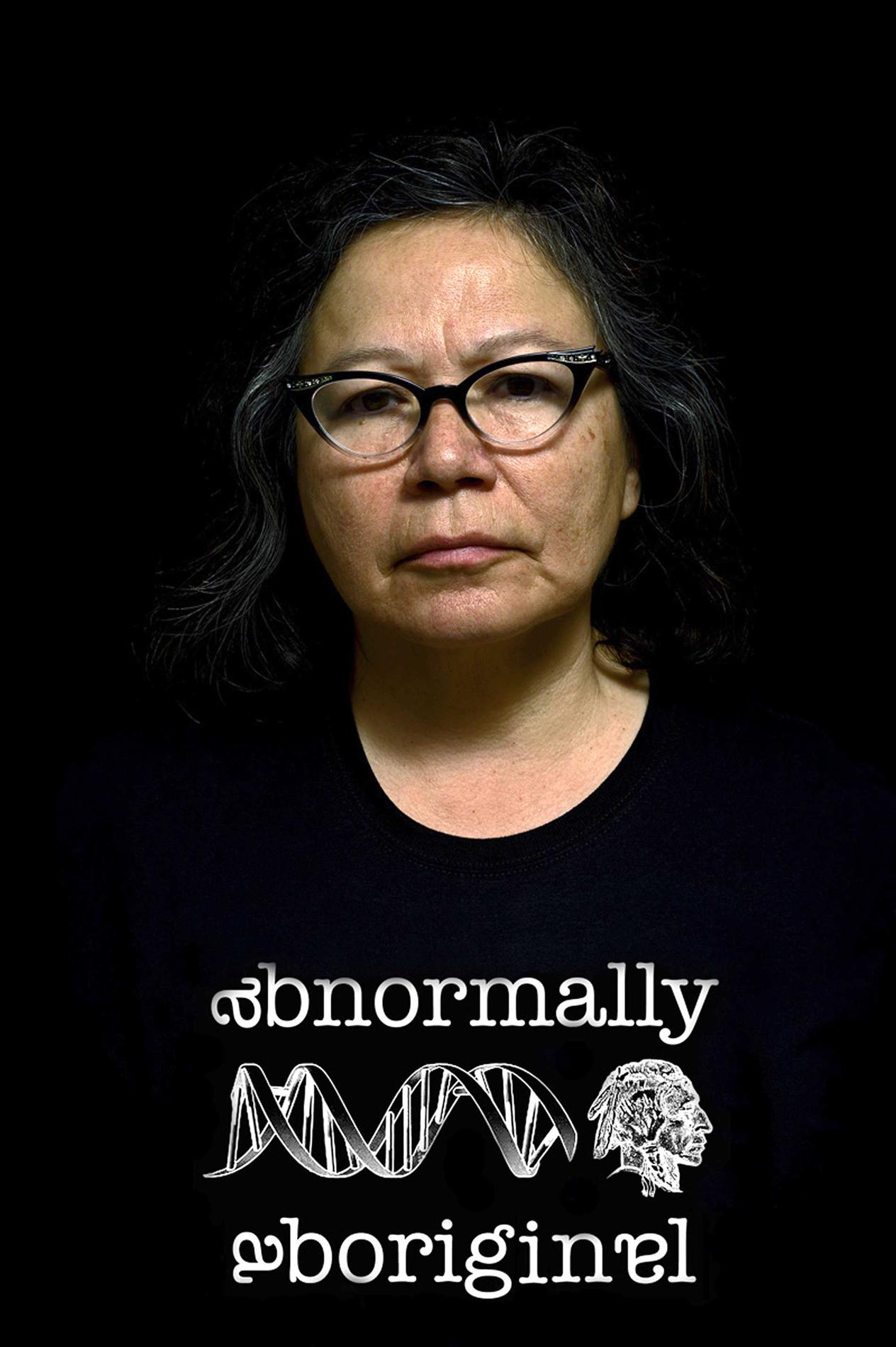 A woman wearing a t-shirt that says "abnormally aboriginal"