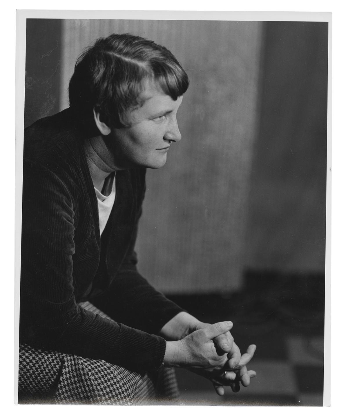 Photograph of Elizabeth McCausland sitting with her hands held together, staring off in the distance