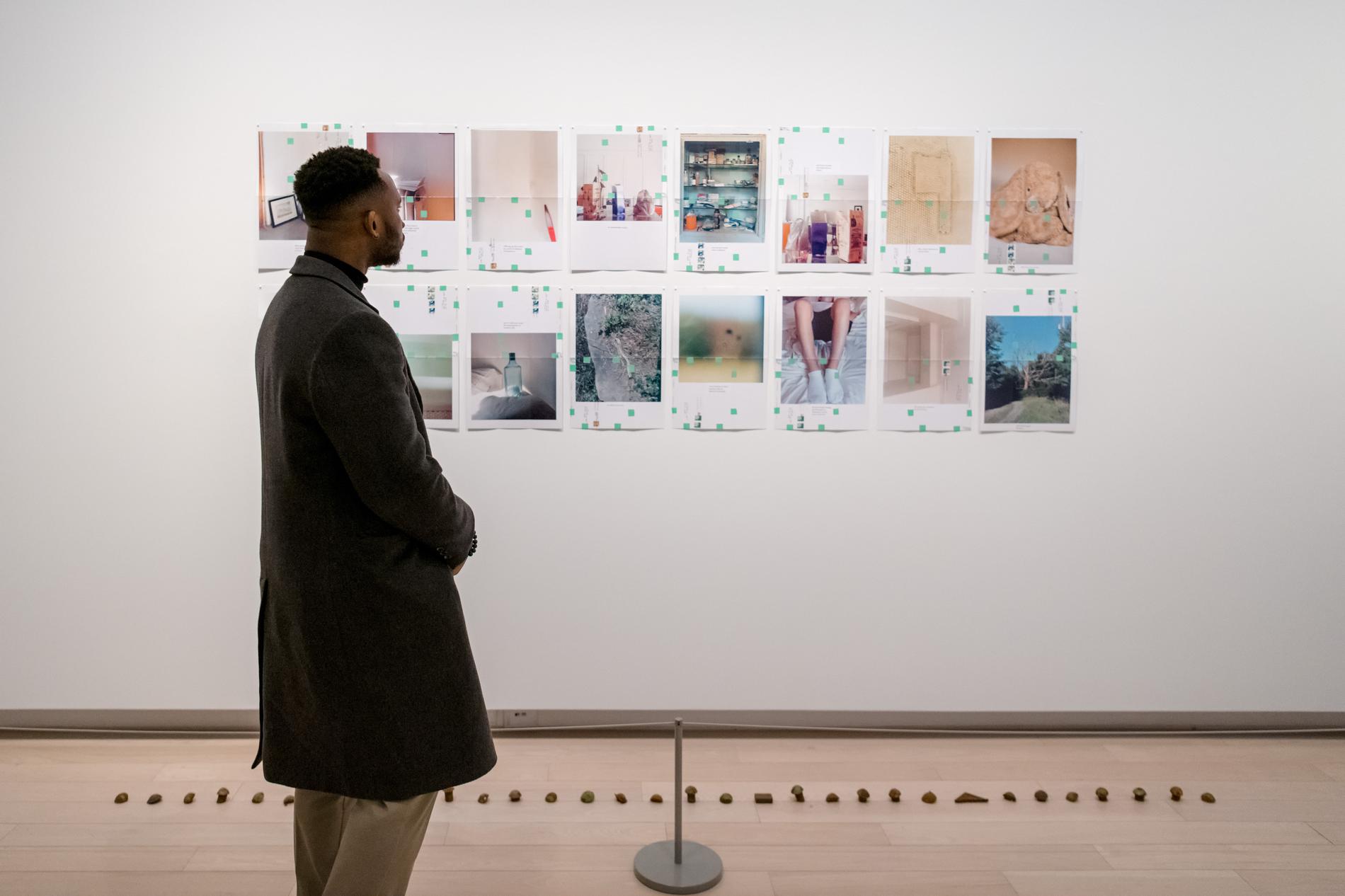A lone man looks at art at the opening of the summer season of exhibitions at The Image Centre in 2019