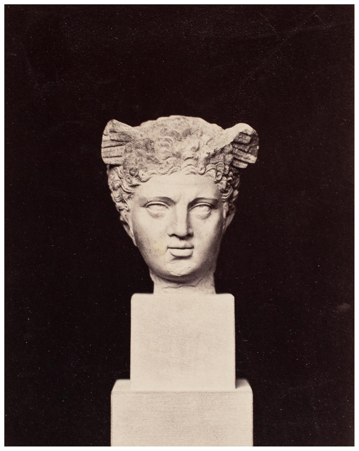 A stone bust shown against a black backdrop. Photograph by Francis Bedford.