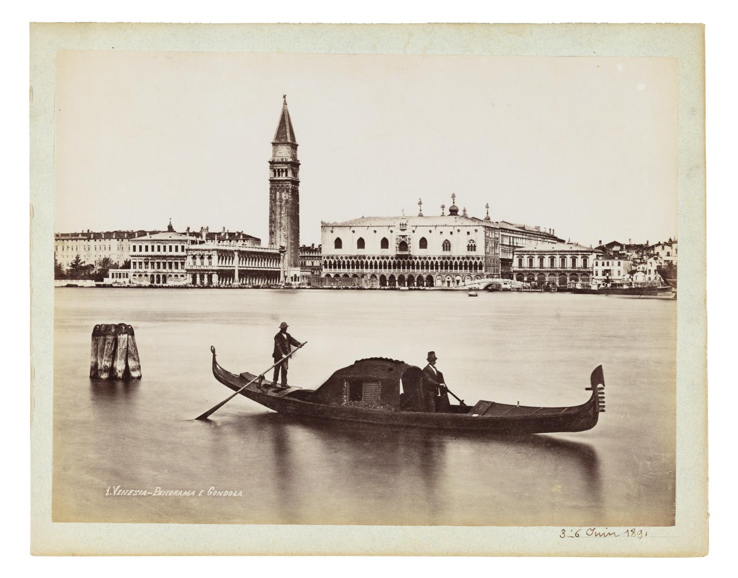 Gondoliers travelling in front of a view of Venice, Italy