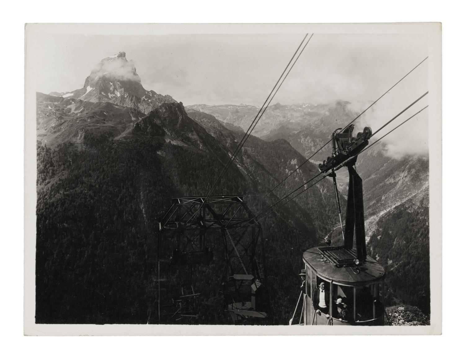 A cable car pictured in a mountainous landscape