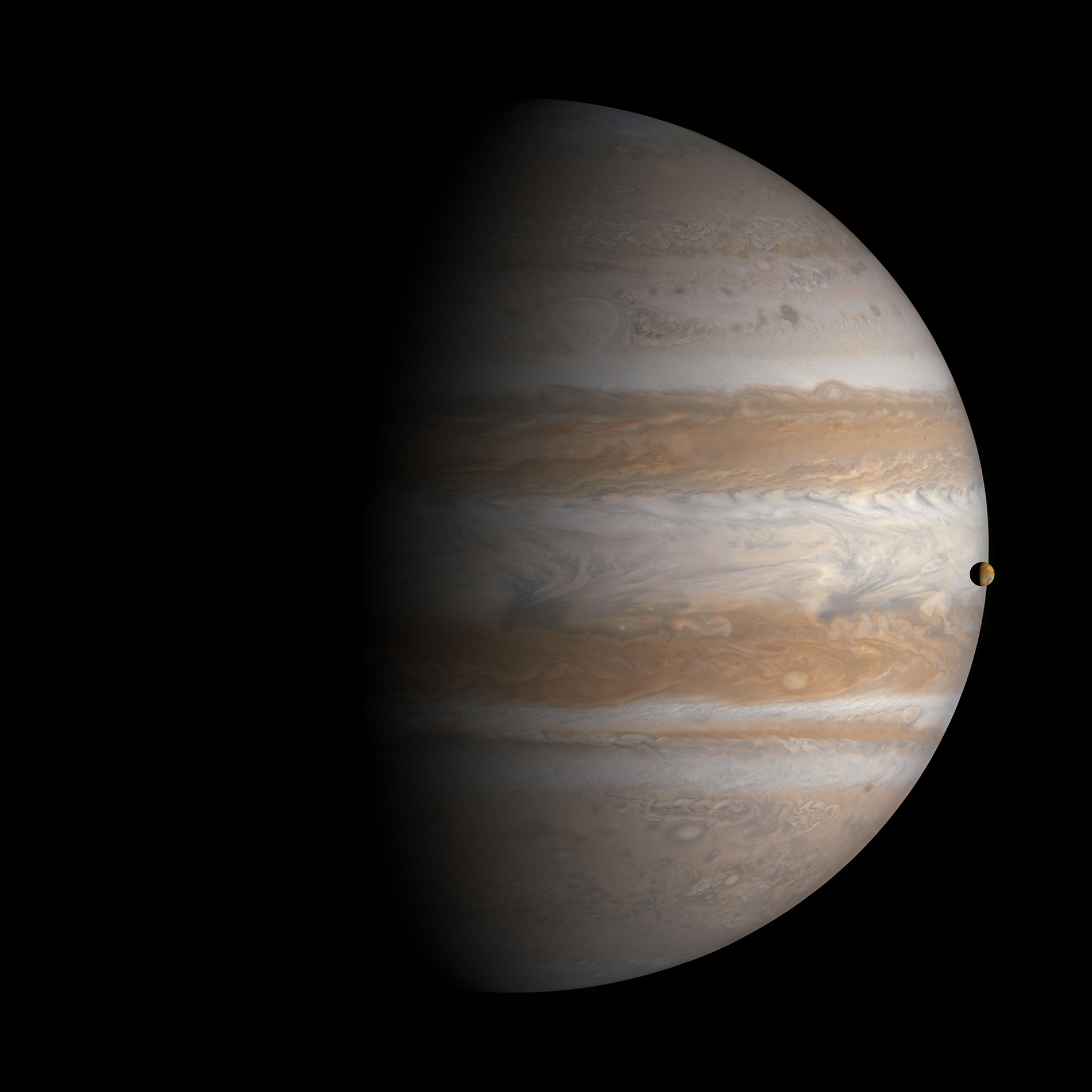 Crisp image of the planet Jupiter, shrouded in darkness to the left of the frame. A smaller orb representing the moon Io orbits around it to the right of the frame.