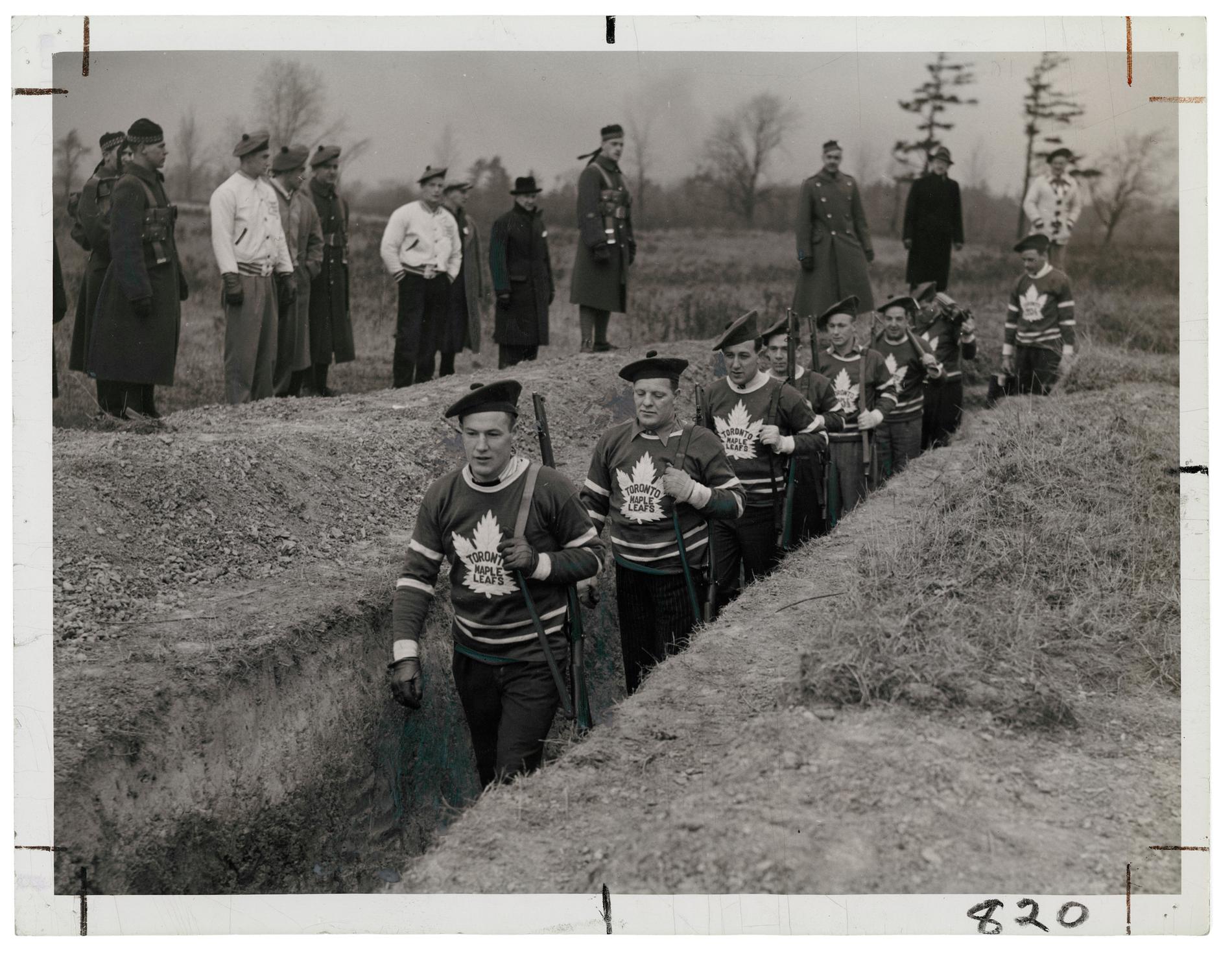 Members of the Toronto Maple Leaf hockey team in the trenches during a military training session in 1939.