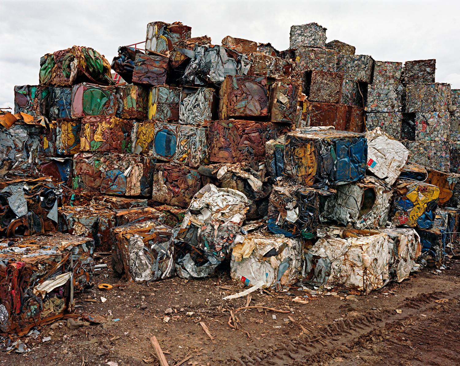 Photograph by Edward Burtynsky. A pile of densified cans.