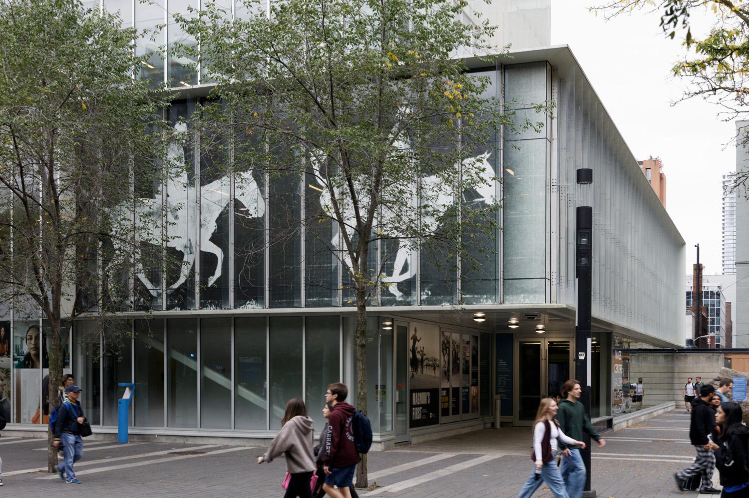 Corner of the gallery building featuring second floor window facade photos of horses in motion