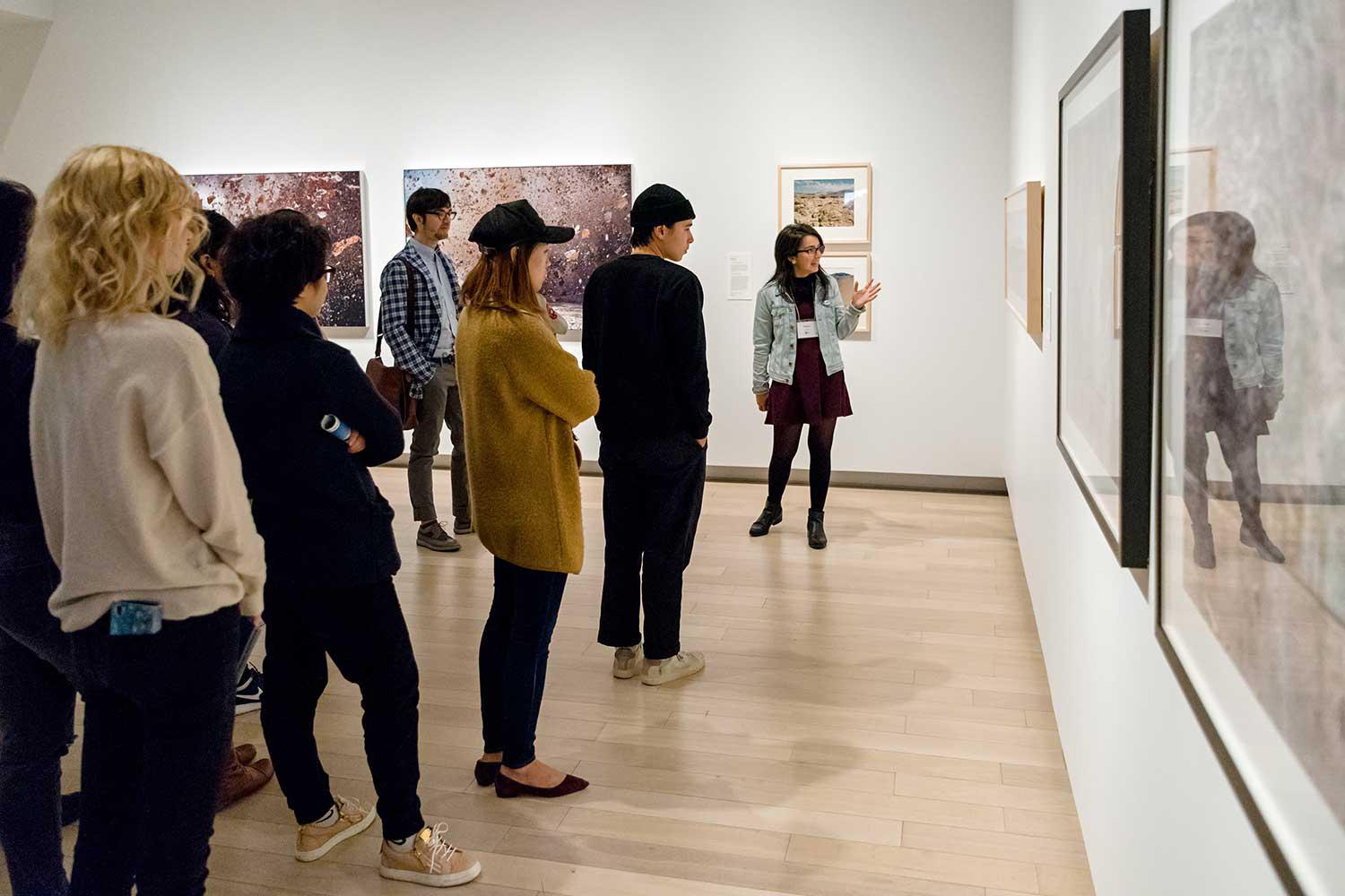 A docent leading a tour of an exhibition