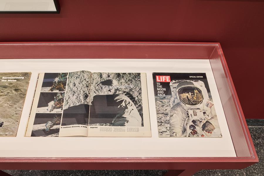 Life magazine spread showing an astronaut landing on the moon on display in a gallery vitrine at The Image Centre