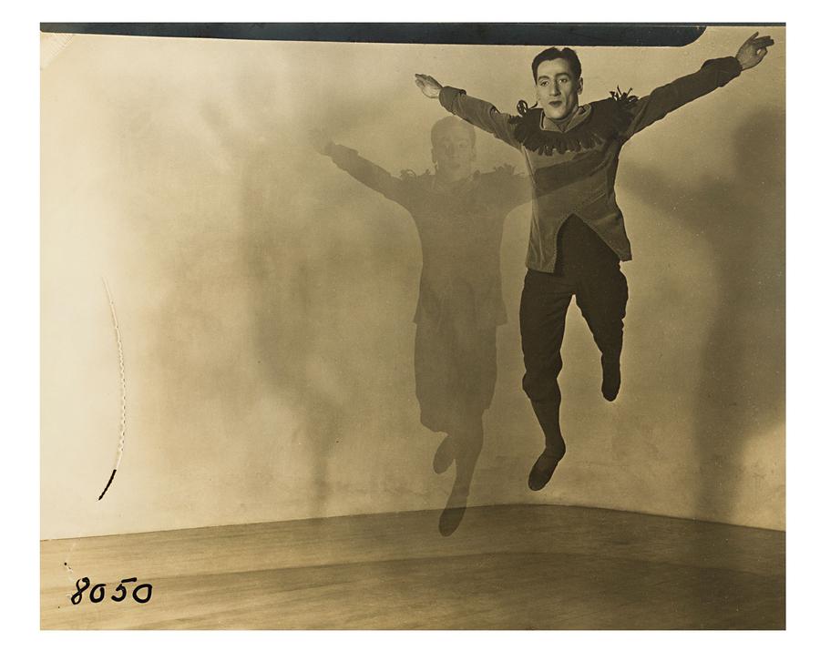 A black and white photo of a man jumping.