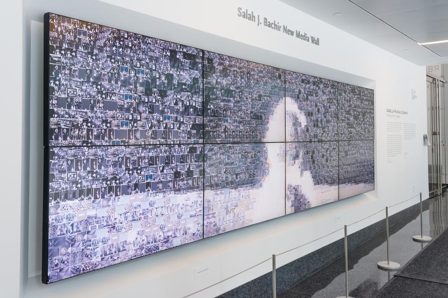 Hundreds of tiny images overlapping on eight rectangular screens, text above reads "Salah J. Bachir New Media Wall"
