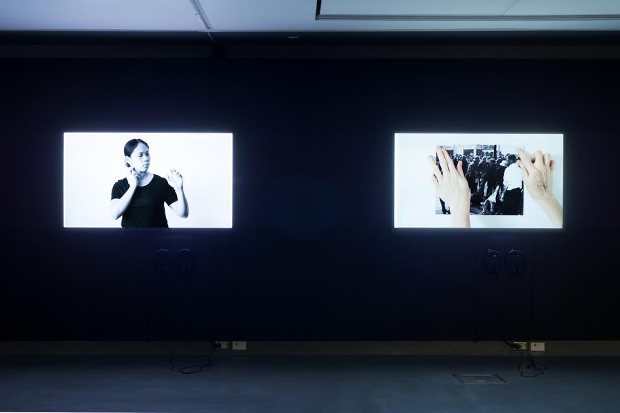 Two video stills side by side. On the left, a woman in a black t-shirt. On the right, two hands holding a photograph.