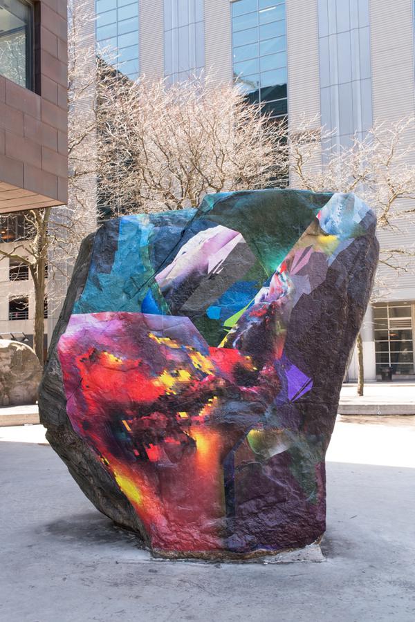 An abstract mural covering a large rock