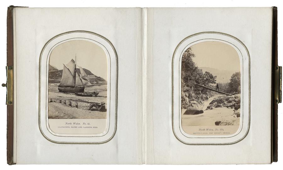 An album spread with two images. On the left an image with a sailboat, and on the right, a man standing on a bridge.