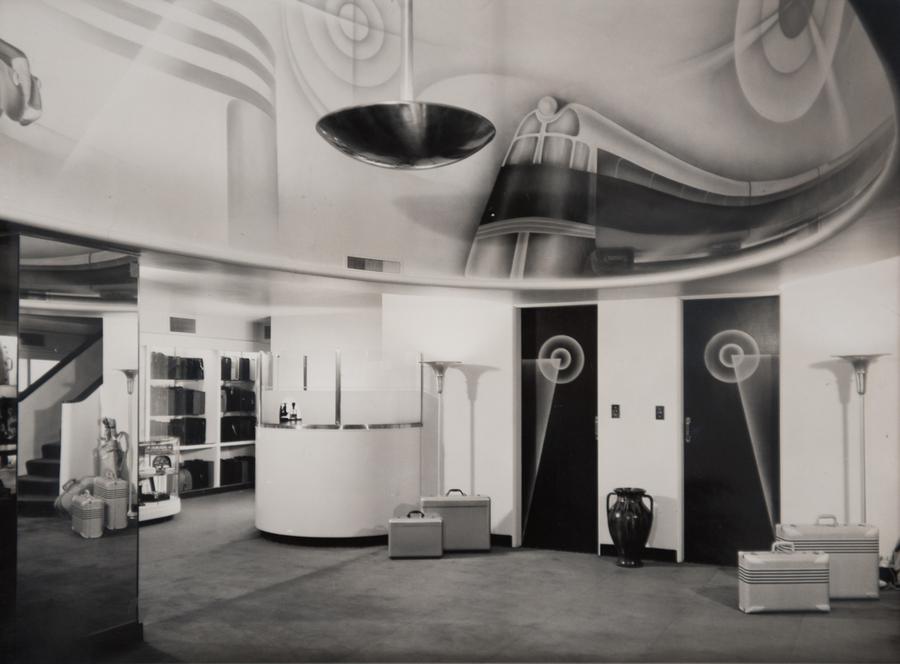 A circular lobby with two black doors and white walls