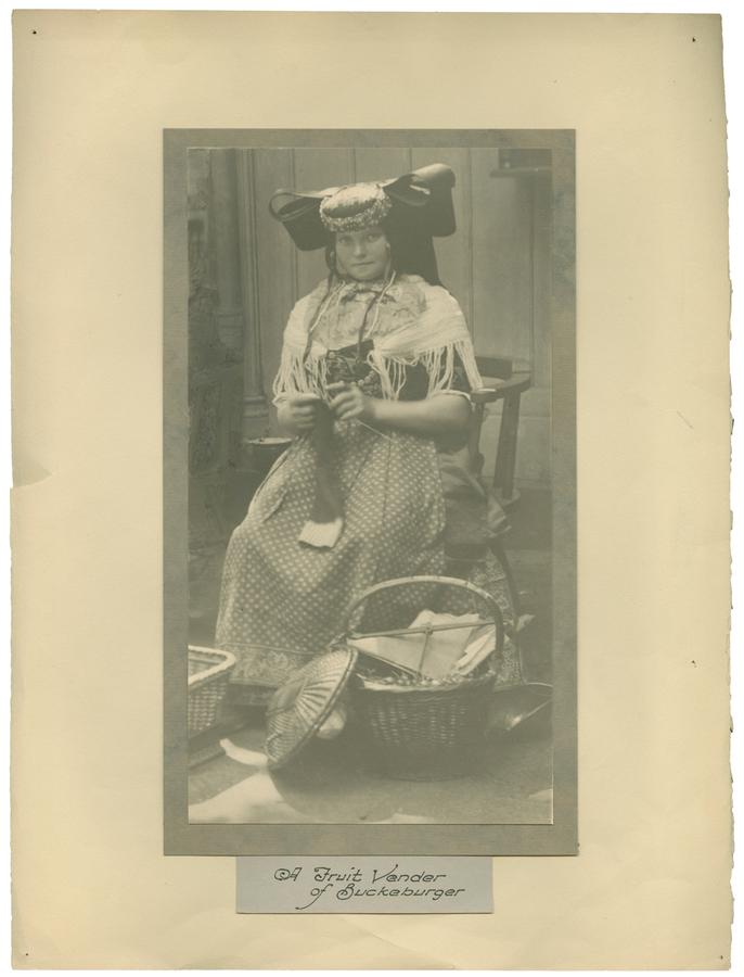 A seated woman wearing traditional dress. Black and white photograph by Minna Keene