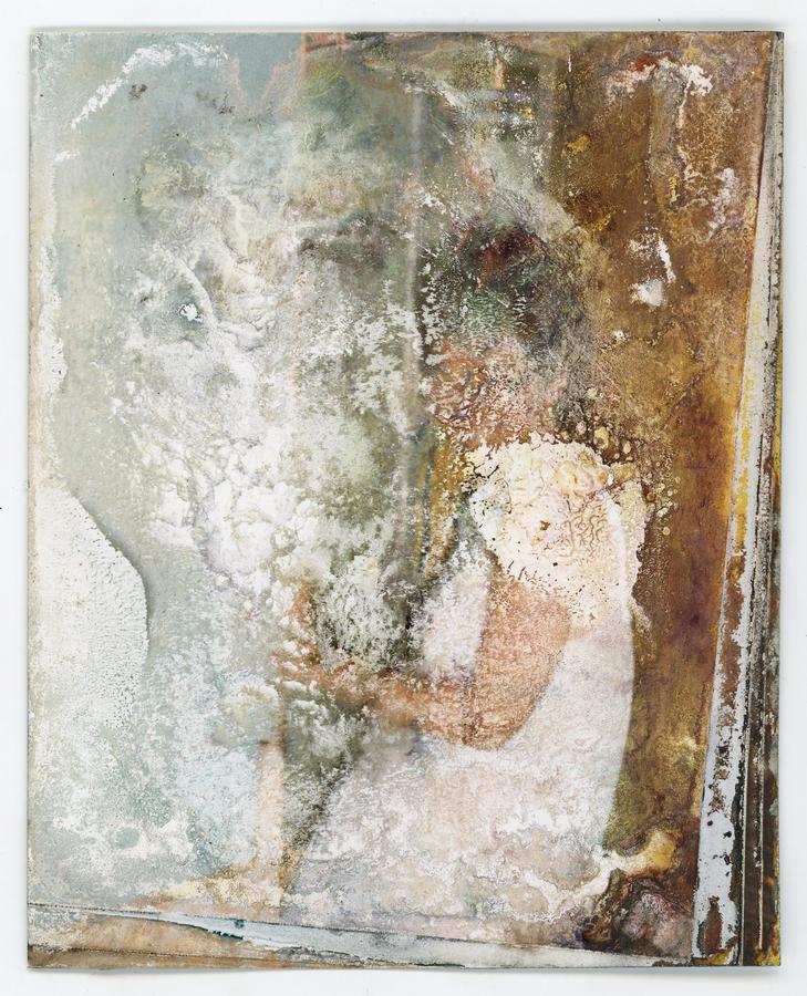 A water-damaged photo with a child barely visible.