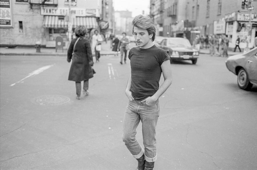 A black and white photograph of a man on a New York street.