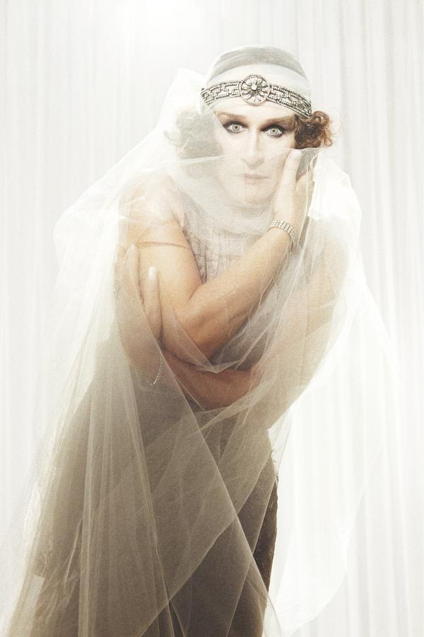 Glen Close wearing a crinoline dress and a silver headpiece