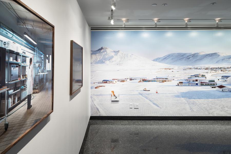 A large photograph of a small snowy town surrounded by mountains