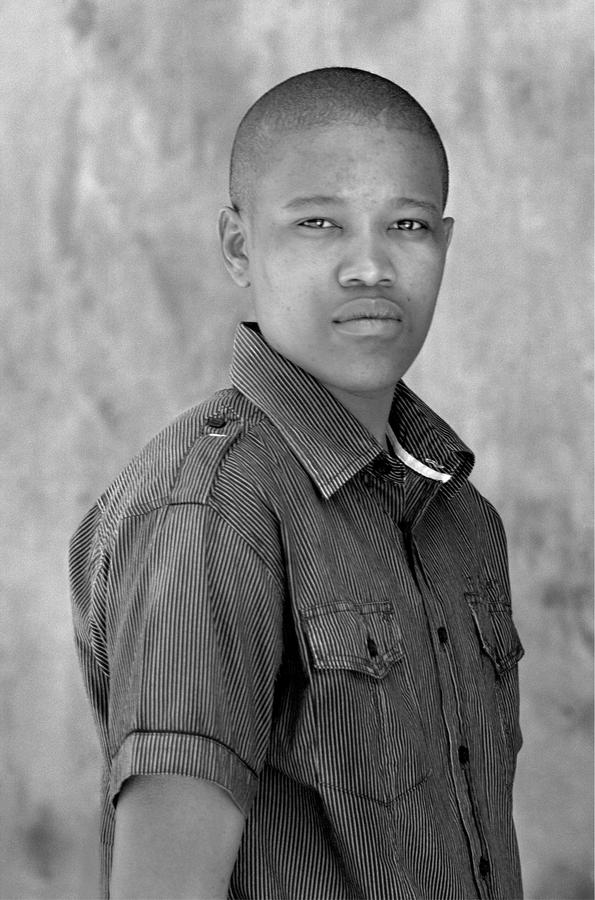 A man in a striped button down short-sleeve shirt