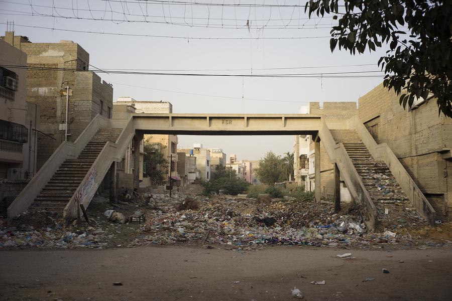 An overpass with a lot of garbage underneath it