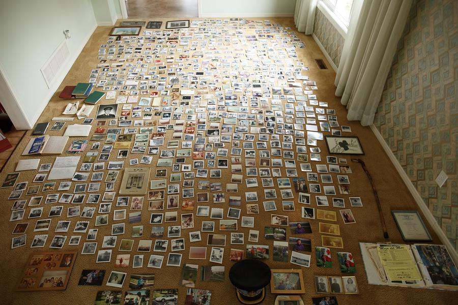 A carpeted room with photographs covering the entire floor.