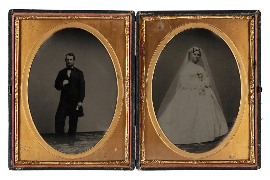 Two sided folding photo holder featuring groom on left photo opening, hand reaching up to touch his suit button. Right photo opening features veiled bride holding flowers.