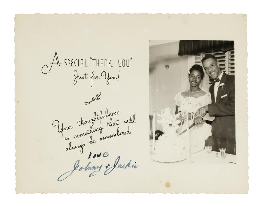 thank you card with the inscription "A Special 'Thank You' Just for You!" and a handwritten from the married couple cutting cake photographed on the card.