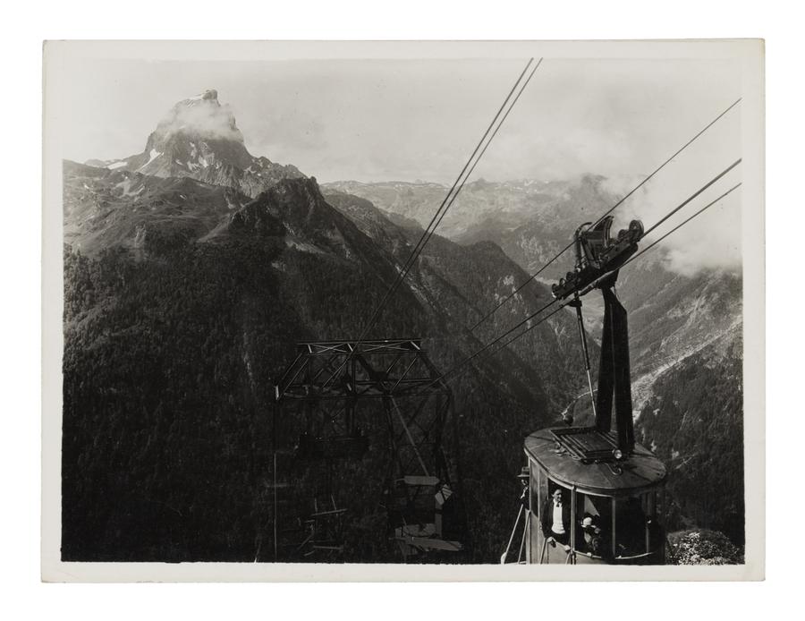 A cable car pictured in a mountainous landscape