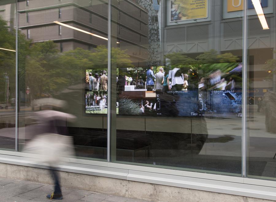 8 video stills of a wedding seen through the windows of the Ryerson Image Centre