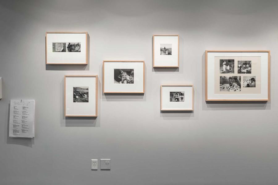 A wall in a gallery full of framed photographs