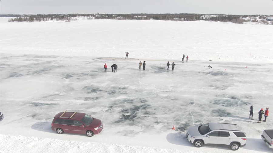A winter scene of skateboarders on an icerink.