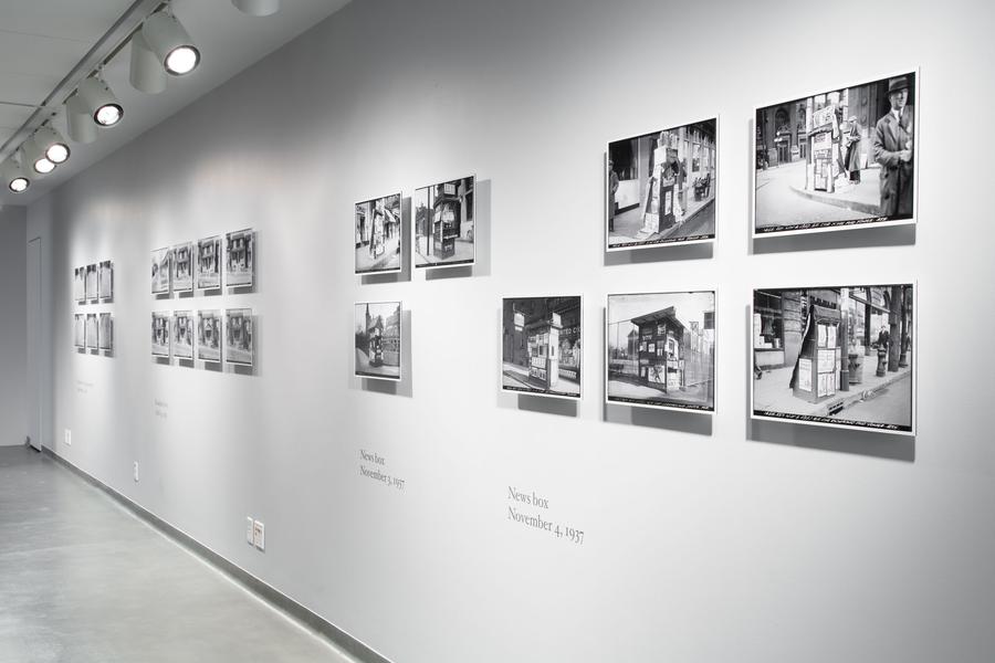 A gallery wall filled with framed photographs
