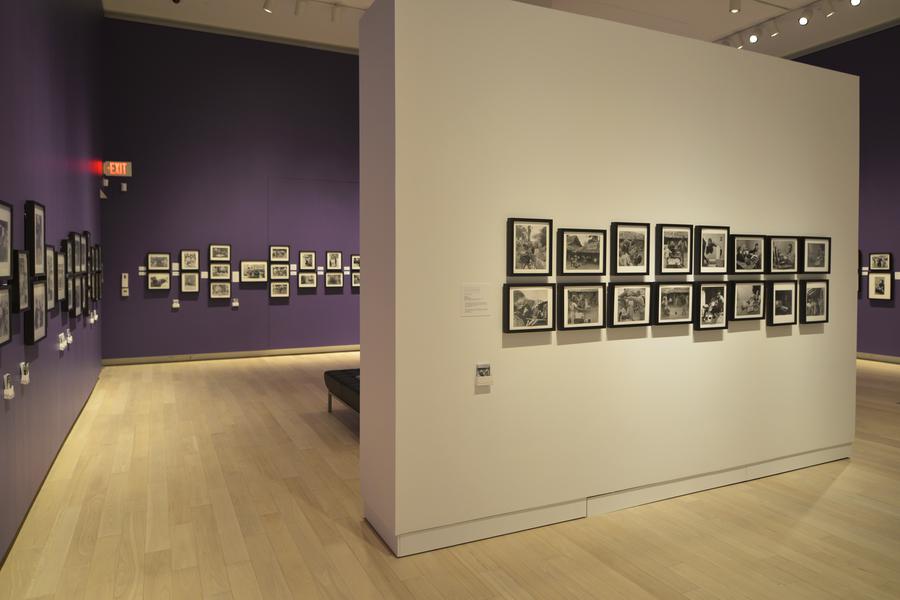 Small photographs on a white or purple wall