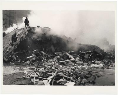 A man standing on a pile of rubble