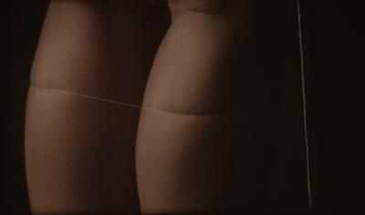 Close up of the back of a woman's legs, with a thin string tied around them